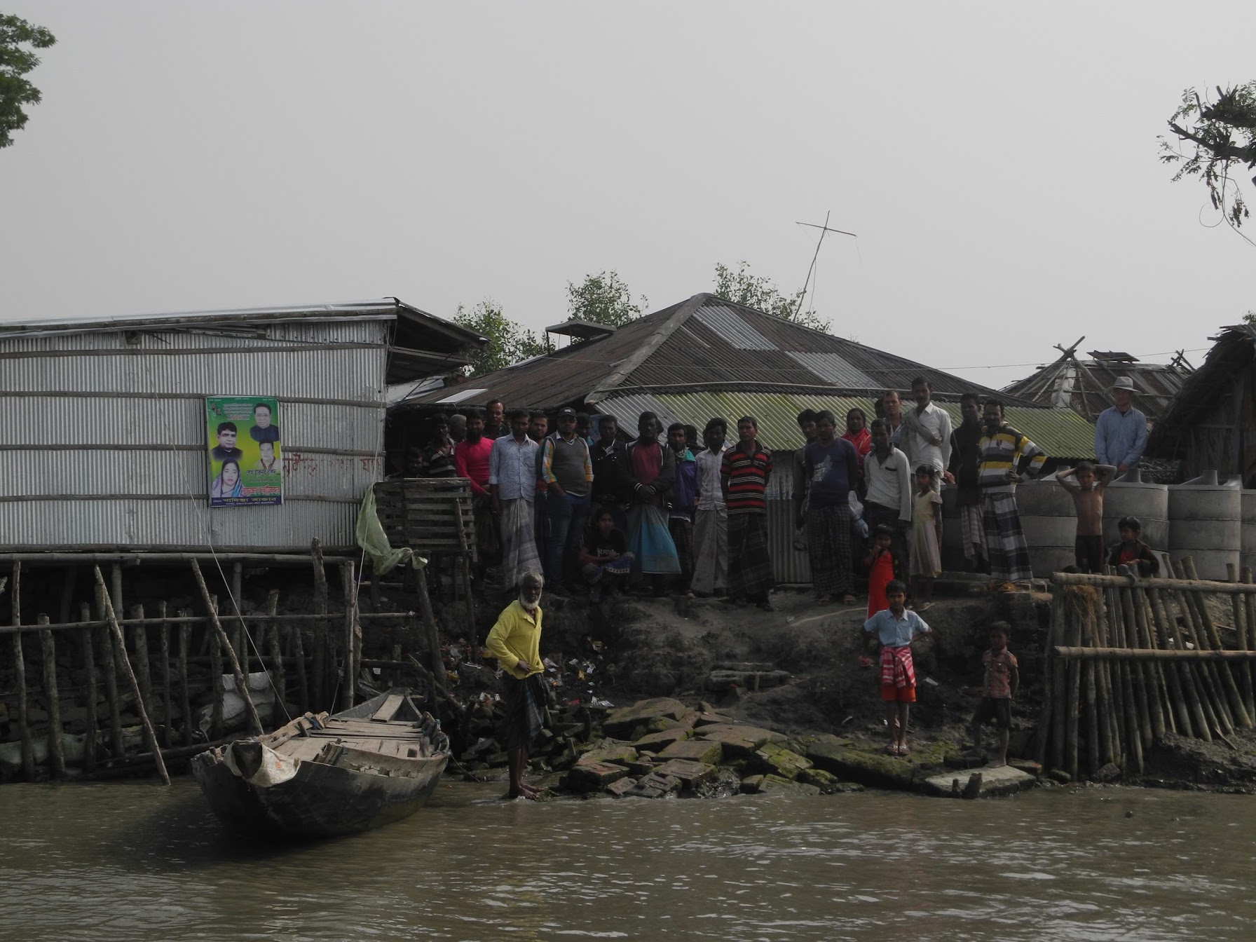 Residents stand at the edge of Polder 32 on the Bangladesh coast. The polder was inundated by Cyclone Aila in 2009. The flooding lasted two years, after the walls surrounding the polder were damaged. Now the walls are being rebuilt. But some scientists warn that's inviting another disaster. Residents of Polder 32 on the Bangladesh coast.