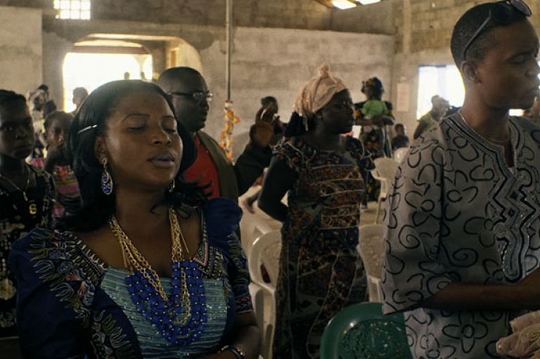 Mabel Musa Every Sunday, Mabel Musa attends church praying for her patients to stop dying from Ebola. Image by DOCDAYS Productions/Carl Gierstorfer. Liberia, 2015.