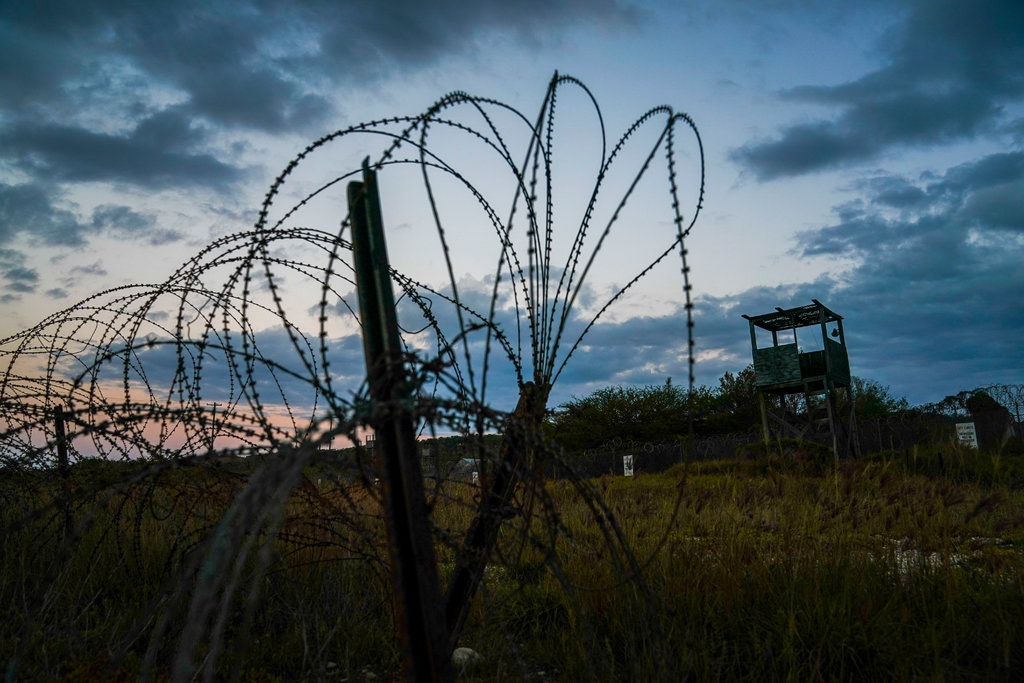 Mohammed al-Qahtani was brutally interrogated by the U.S. military at Camp X-Ray, above, a detention facility at Guantánamo Bay. Image by Doug Mills/The New York Times. Cuba, 2020. Mohammed al-Qahtani was brutally interrogated by the U.S. military at Camp X-Ray, above, a detention facility at Guantánamo Bay. Image by Doug Mills/The New York Times. Cuba, 2020.