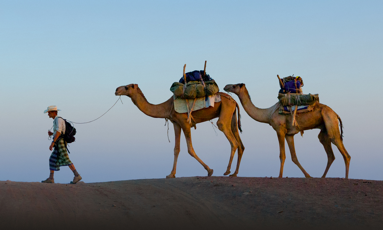 Two weeks into the Out of Eden Walk, Paul Salopek and local guides traverse the Afar region of northeastern Ethiopia. Image by John Stanmeyer / National Geographic. Ethiopia, 2013. Two weeks into the Out of Eden Walk, Paul Salopek and local guides traverse the Afar region of northeastern Ethiopia. Image by John Stanmeyer / National Geographic. Ethiopia, 2013.