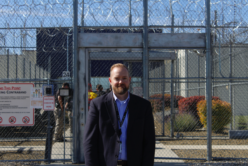 Idaho Department of Correction Director Josh Tewalt stands in front of the Idaho State Correctional Center. Image by Madelyn Beck / Boise State Public Radio. United States, 2020.