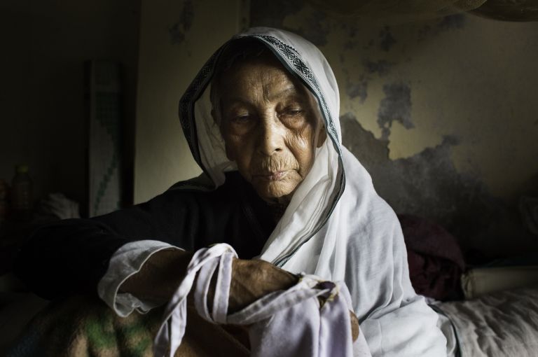 Tarash Mandir An elderly widow in her bed at Tarash Mandir, a short-stay home for young women and permanent facility for elderly widows in Vrindavan, India. This is the first and oldest home for widows in Vrindavan. Image by Amy Toensing. India, 2016.