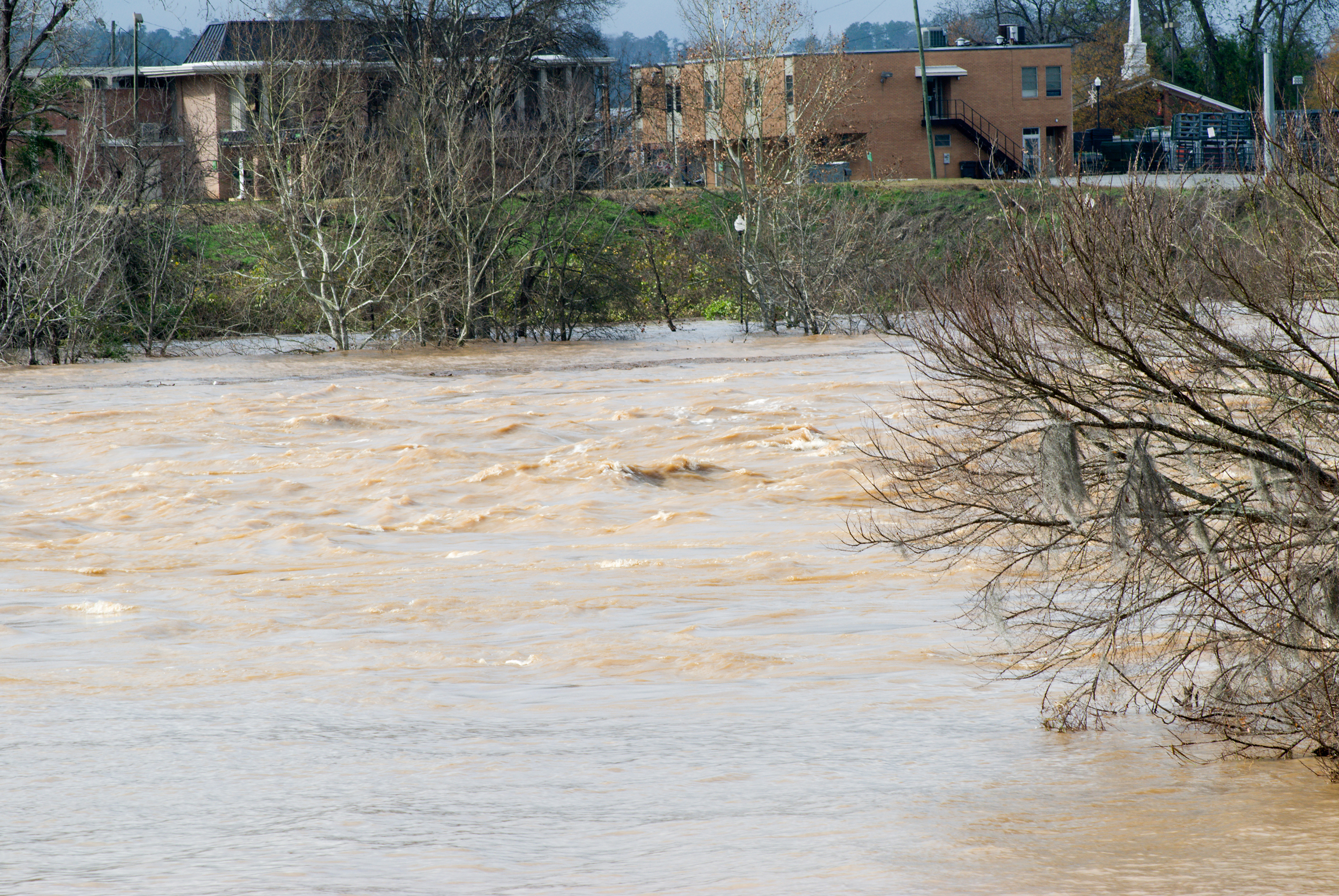 Columbus, Georgia: View of the Chattahoochee River from the riverwalk as it reaches flood levels after several days of non-stop rainy weather. Image by Vizual Studio / Shutterstock. USA, 2015. Columbus, Georgia: View of the Chattahoochee River from the riverwalk as it reaches flood levels after several days of non-stop rainy weather. Image by Vizual Studio / Shutterstock. USA, 2015.