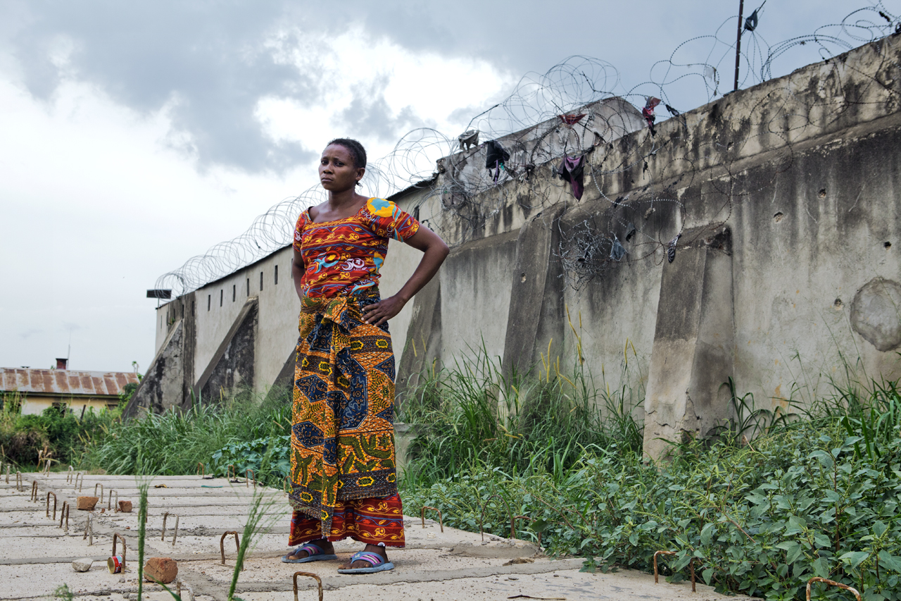 Masika Daya, abducted by Morgan to be one of his ten "wives," stands in the grounds of the prison in Bunia where she is held by local authorities. Image by Francesca Tosarelli. Democratic Republic of Congo, 2013. Media file: _MG_3050.jpg