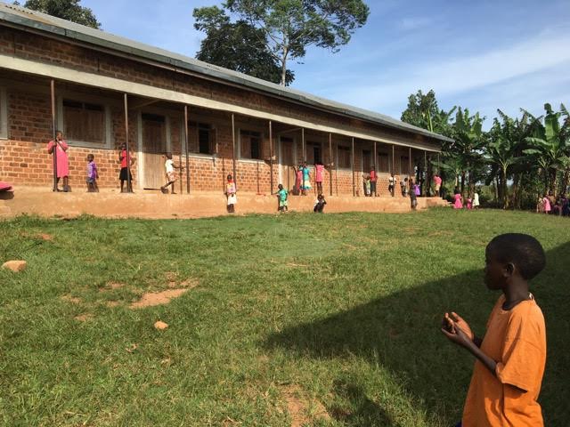 Students play in the school yard of a Building Tomorrow School as they wait to receive their report cards. Image by Brandon Posner. Uganda, 2016. Students play in the school yard of a Building Tomorrow School as they wait to receive their report cards. Image by Brandon Posner. Uganda, 2016.