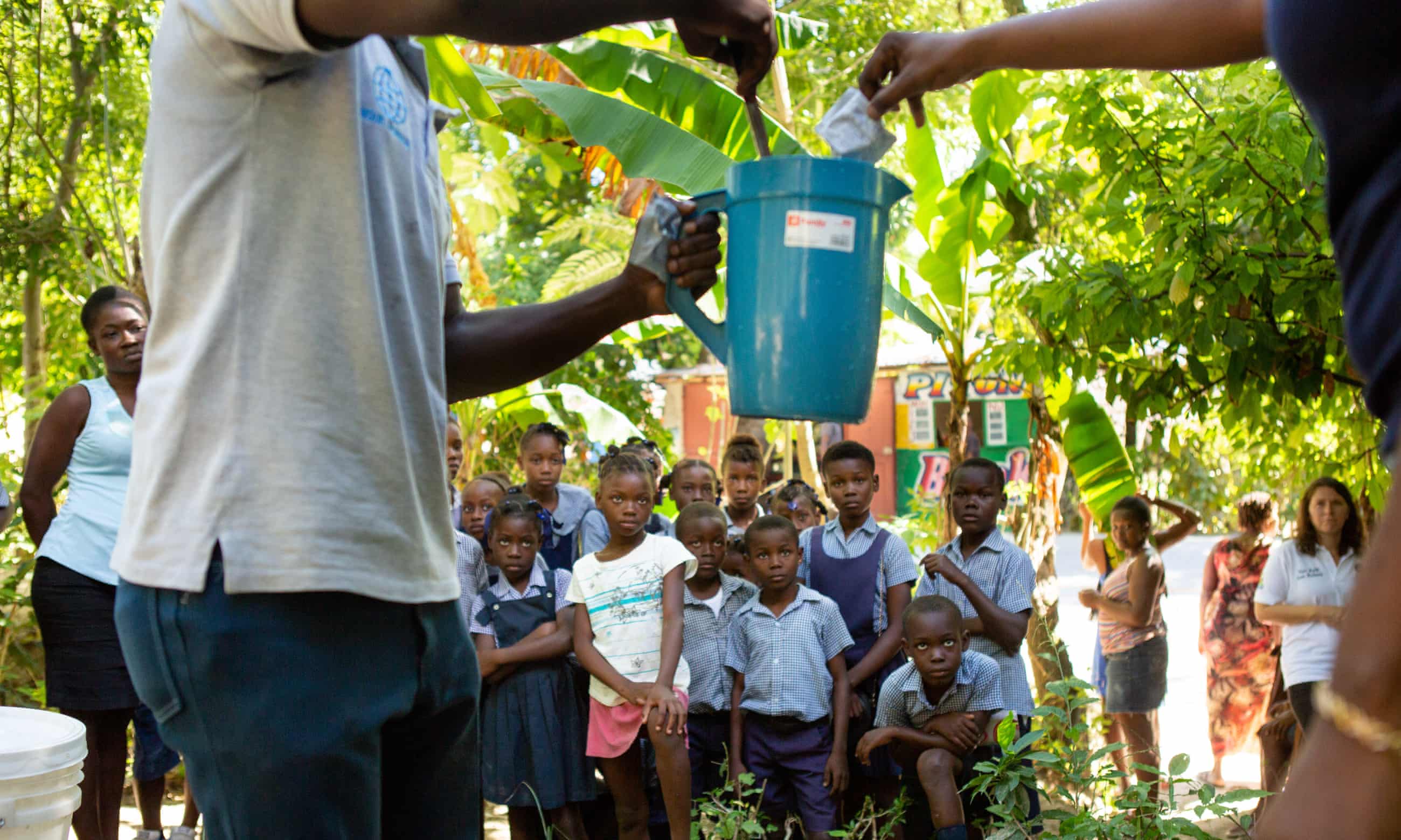 School children near Mirebalais are shown how to mix oral rehydration solution as part of an effort to head off any recurrence of cholera in Haiti. Image by Allison Shelley. Haiti, 2020. School children near Mirebalais are shown how to mix oral rehydration solution as part of an effort to head off any recurrence of cholera in Haiti. Image by Allison Shelley. Haiti, 2020.