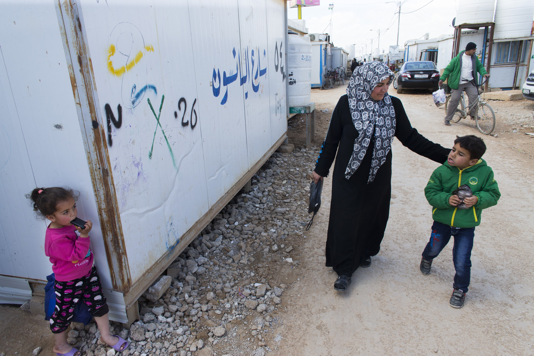 Solaad Nader walks her six-year-old son, Omar, back to their home after being evaluated by Brookfield pediatric neurologist Tarif Bakdash. The family with their four children survived their house being bombed in Syria and Omar had to be dug out from the rubble. They have been at the camp slightly more than three years. Image by Mark Hoffman. Jordan, 2016. Media file: jordan3.jpg