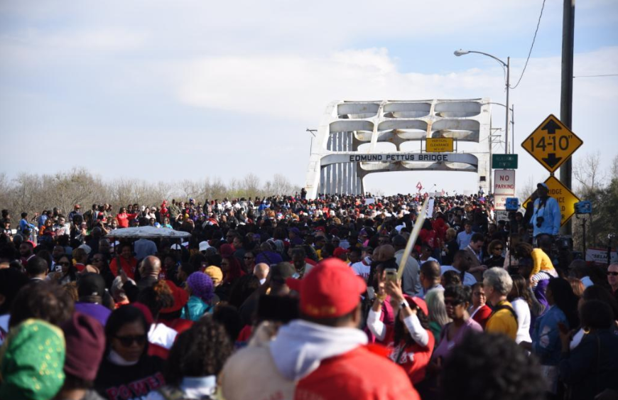 Marchers commemorating the ‘Bloody Sunday’ events of 1965 approach the Edmund Pettus Bridge, in Selma, Alabama, this past Sunday. Image by Brittany Gibson. United States, 2020. Marchers commemorating the ‘Bloody Sunday’ events of 1965 approach the Edmund Pettus Bridge, in Selma, Alabama, this past Sunday. Image by Brittany Gibson. United States, 2020.