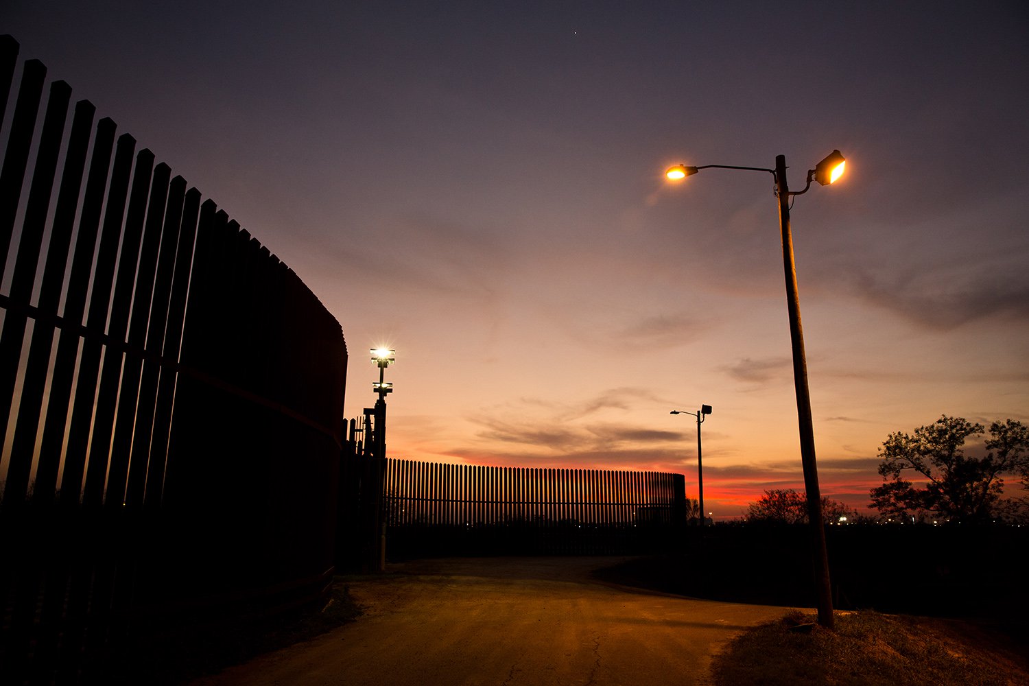 The border fence and levee pass through the Lower Rio Grande Valley National Wildlife Refuge in Hidalgo. Image by Callie Richmond. United States, 2017. The border fence and levee pass through the Lower Rio Grande Valley National Wildlife Refuge in Hidalgo. Image by Callie Richmond. United States, 2017.