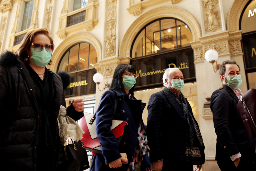 Tourists in face masks at the Wiktor Emanuel II Gallery in Italy. Image by Praszkiewicz / Shutterstock. Italy, 2020. Tourists in face masks at the Wiktor Emanuel II Gallery in Italy. Image by Praszkiewicz / Shutterstock. Italy, 2020.