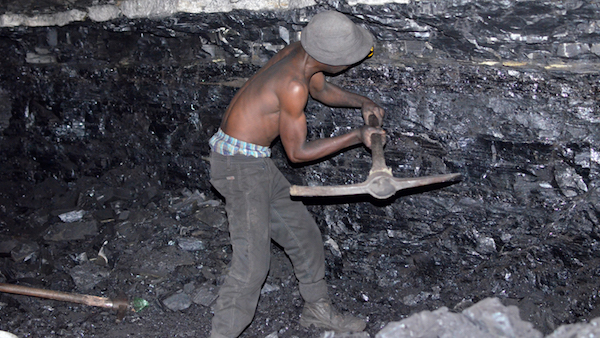 A small-scale miner illegally digs coal from an abandoned, former Anker Coal operation just outside Ermelo, Mpumalanga. Image by Mark Olalde. South Africa, 2017. A small-scale miner illegally digs coal from an abandoned, former Anker Coal operation just outside Ermelo, Mpumalanga. Image by Mark Olalde. South Africa, 2017.