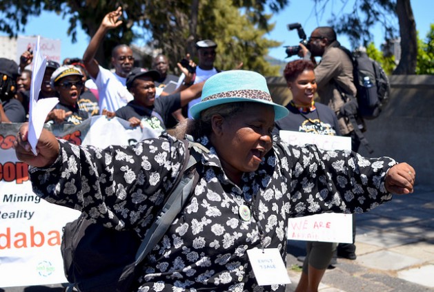 A delegate of the Alternative Mining Indaba dances during a protest march in Cape Town, South Africa, in February. Image by Mark Olalde. South Africa, 2017. A delegate of the Alternative Mining Indaba dances during a protest march in Cape Town, South Africa, in February. Image by Mark Olalde. South Africa, 2017.
