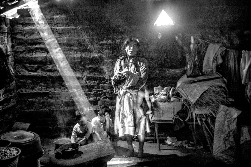 A family in El Chuparosa, Guerrero. When rain poured through their roof, the father said, “The house is crying.” Image by Matt Black. Mexico, 2014. Media file: monster_final01-1200_1.jpg