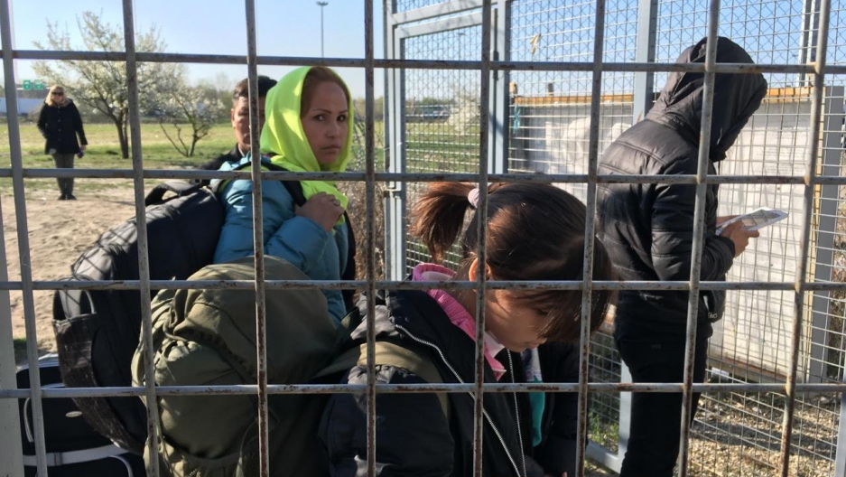 An Afghan refugee family enters Hungary from Serbia. Under a controversial new Hungarian border law, they live in a detention camp at the border until their case is decided. Image by Jeanne Carstensen. Hungary, 2017. An Afghan refugee family enters Hungary from Serbia. Under a controversial new Hungarian border law, they live in a detention camp at the border until their case is decided. Image by Jeanne Carstensen. Hungary, 2017.