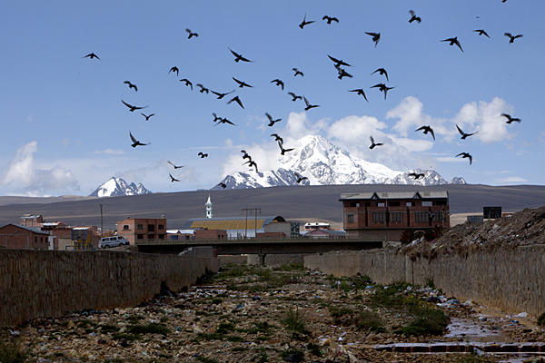 The Rio Seco, which originates at the Huayna Potosi glacier, winds through the city of El Alto, Bolivia, gathering trash as the water eventually feeds Lake Titicaca, where indigenous communities are suffering the effects of pollution. Image by Noah Friedman-Rudovsky. Bolivia, 2011.