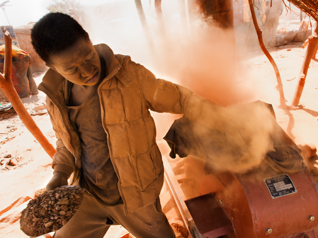 Rock crushers pulverize gold ore into a fine powder which is then processed with mercury to obtain pure gold. Children constantly breathe the dust created by the machines. Image by Larry C. Price. Burkina Faso, 2013.