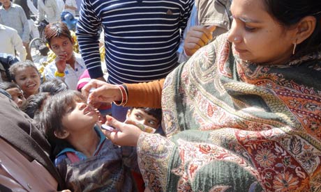 A healthworker administers a dose of oral polio vaccine in Aligarh, where progress is being made against the disease despite cultural obstacles. Image by Esha Chhabra. India, 2013. Media file: MDG--Unicef-polio-health--008.jpg
