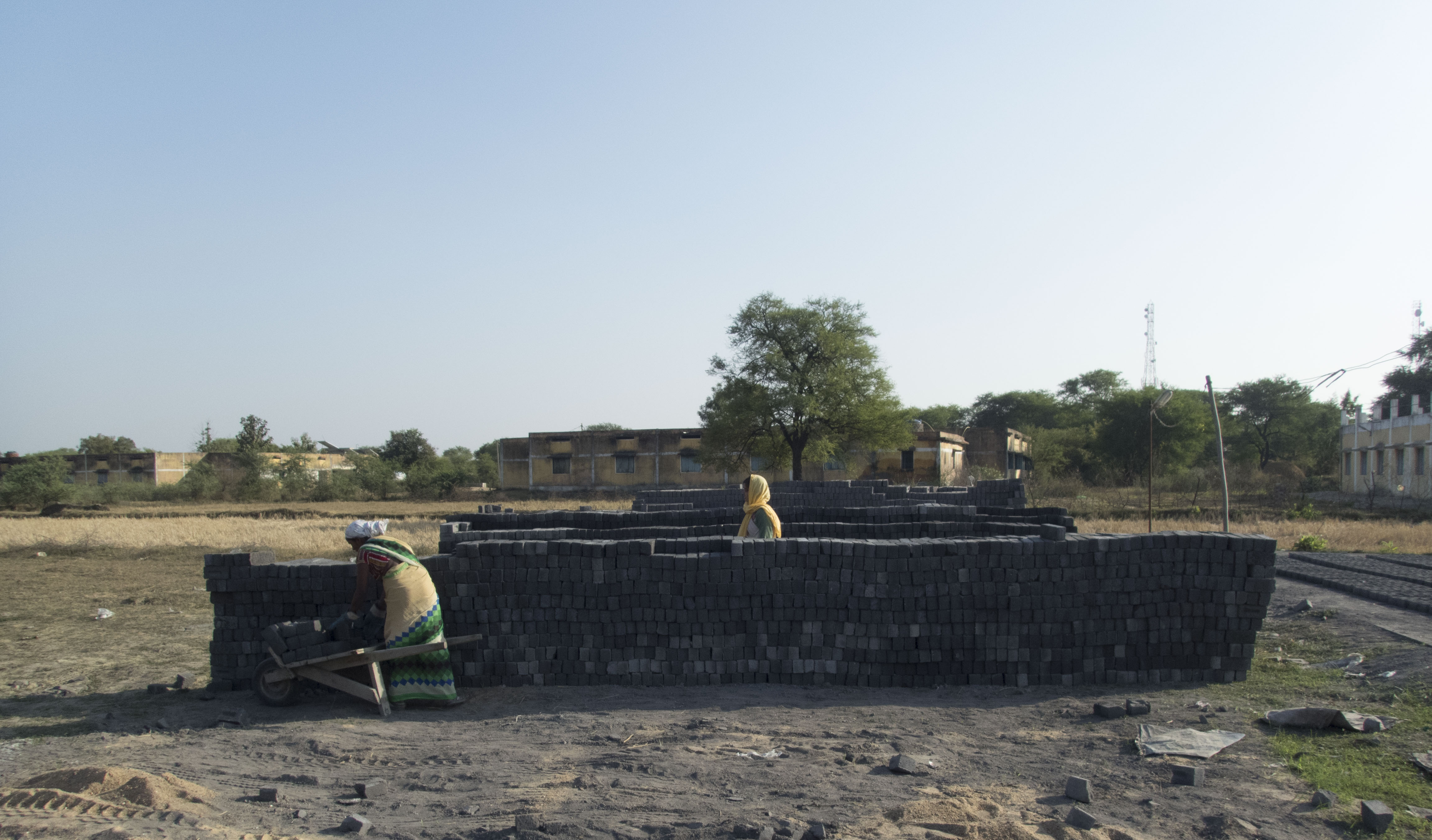 Women working at a small, temporary brick factory in Malda village. While most of the laborers at this factory were local relatives of the owner, the industry is notorious for exploiting migrant labor. Image by Yardain Amron. India, 2016. Women working at a small, temporary brick factory in Malda village. While most of the laborers at this factory were local relatives of the owner, the industry is notorious for exploiting migrant labor. Image by Yardain Amron. India, 2016.