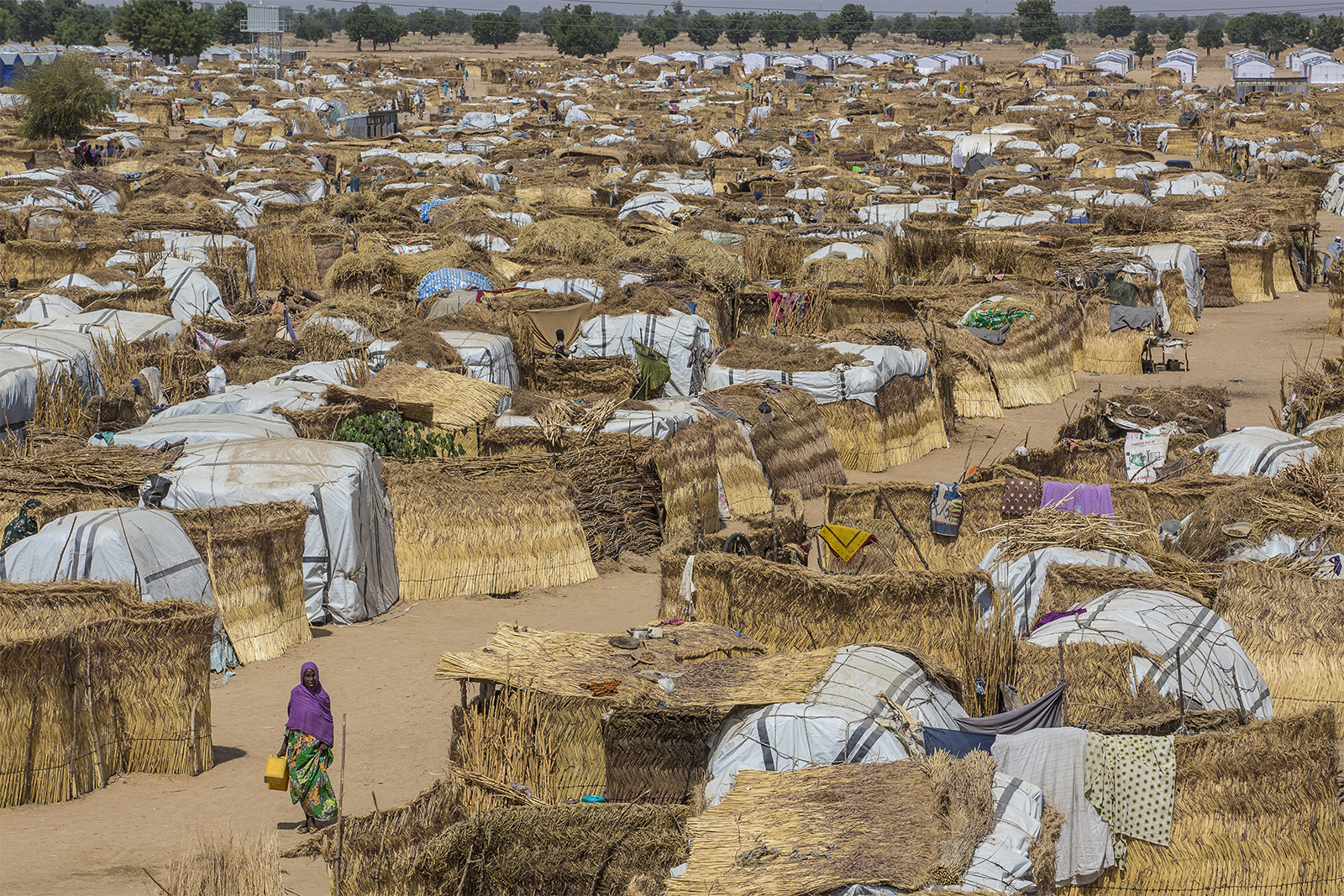 Muna Garage is one of the largest informal camps in Maiduguri, the capital city of Borno state in Nigeria. Nearly 2 million people who have escaped the violence of Boko Haram are internally displaced; thousands have crowded into this camp, where food, water, and sanitation are scarce. Image by Andrew Esiebo/Associated Press. Muna Garage is one of the largest informal camps in Maiduguri, the capital city of Borno state in Nigeria. Nearly 2 million people who have escaped the violence of Boko Haram are internally displaced; thousands have crowded into this camp, where food, water, and sanitation are scarce. Image by Andrew Esiebo/Associated Press.