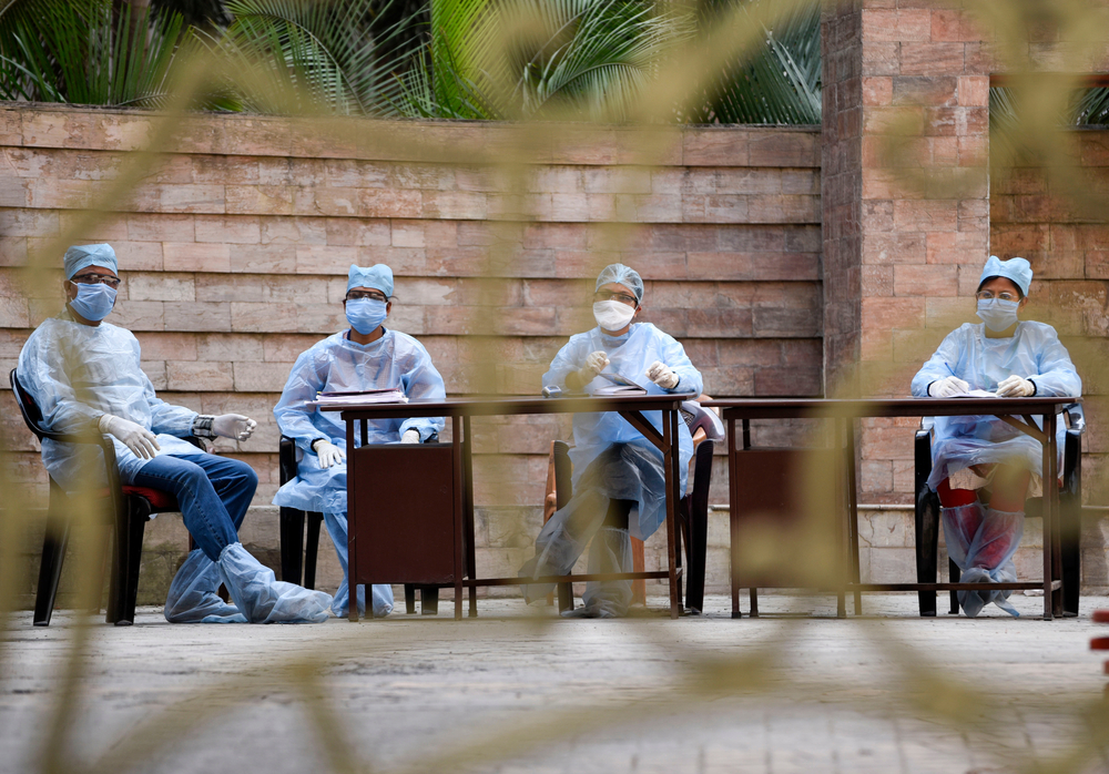 Medics arrive to take blood samples of residents of Spanish Garden residential complex after a COVID-19 positive case was detected in an apartment, in Guwahati. Image by David Talukdar / Shutterstock. India, 2020. Medics arrive to take blood samples of residents of Spanish Garden residential complex after a COVID-19 positive case was detected in an apartment, in Guwahati. Image by David Talukdar / Shutterstock. India, 2020.