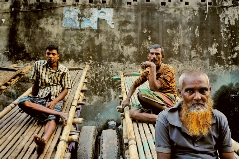 Tannery Workers Tannery workers take a break before noon prayers. Their carts can carry a ton of goat skins through the narrow streets of Hazaribagh. Image by Larry C. Price. Bangladesh, 2016.