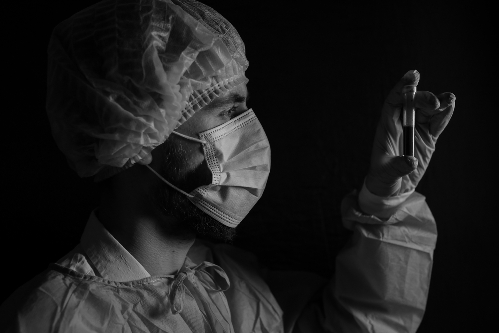 A doctor examines a blood sample. Image by Alena Marchuk / Shutterstock. 2020. A doctor examines a blood sample. Image by Alena Marchuk / Shutterstock. 2020.