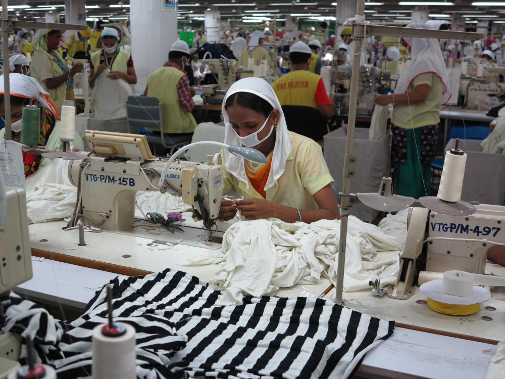 A worker sits at her sewing machine. Bangladesh is second only to China in the global fashion business. Image by Fred de Sam Lazaro. Bangladesh, 2013. Media file: img_0737.jpg