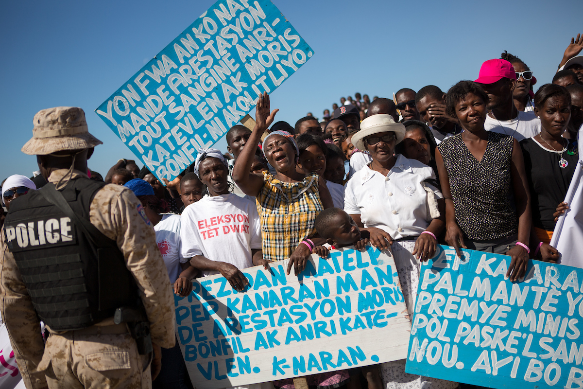 Protesters at a memorial commemorating the five-year anniversary of the 2010 earthquake. Image by Allison Shelley. Haiti, 2016. Protesters at a memorial commemorating the five-year anniversary of the 2010 earthquake. Image by Allison Shelley. Haiti, 2016.