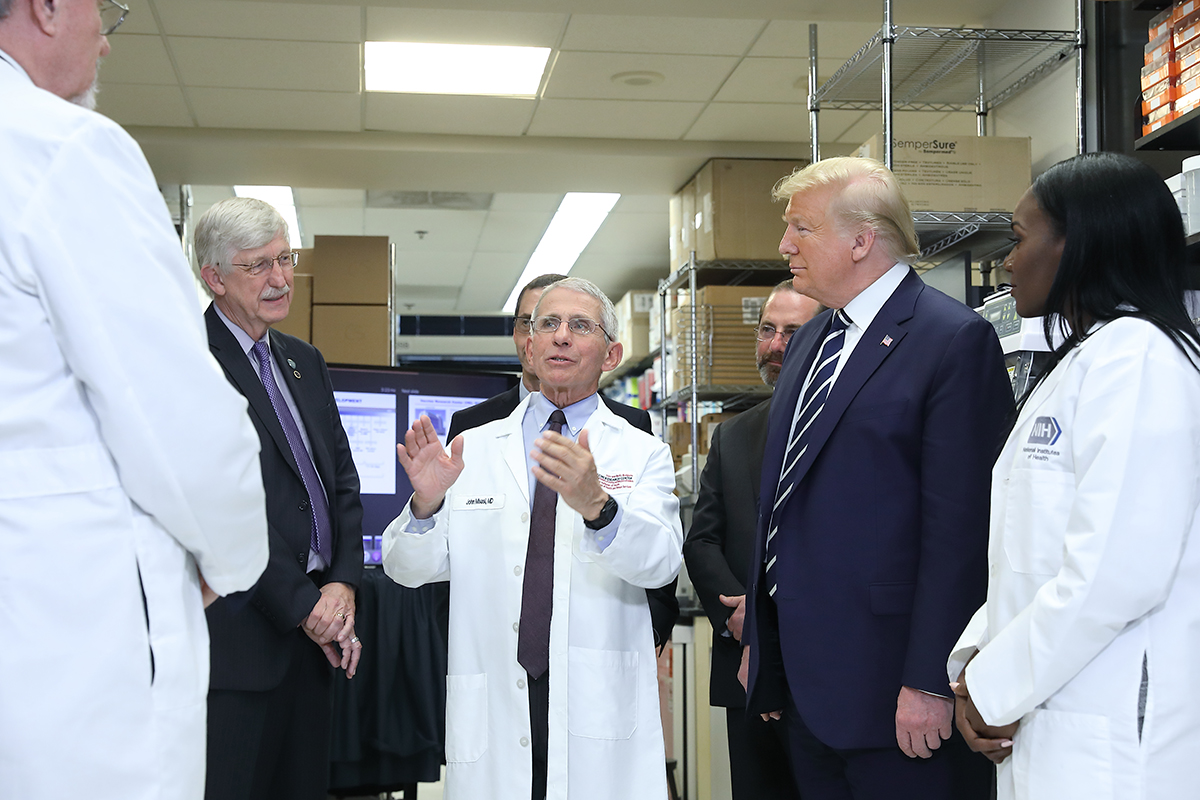 From left: VRC Deputy Director Dr. Barney Graham, NIH Director Dr. Francis Collins, VRC Director John Mascola, Department of Health and Human Services Secretary Alex Azar, President Trump, and VRC Research Fellow Dr. Kizzmekia Corbett. Image courtesy National Institutes of Health. United States, 2020. From left: VRC Deputy Director Dr. Barney Graham, NIH Director Dr. Francis Collins, VRC Director John Mascola, Department of Health and Human Services Secretary Alex Azar, President Trump, and VRC Research Fellow Dr. Kizzmekia Corbett. Image courtesy National Institutes of Health. United States, 2020.