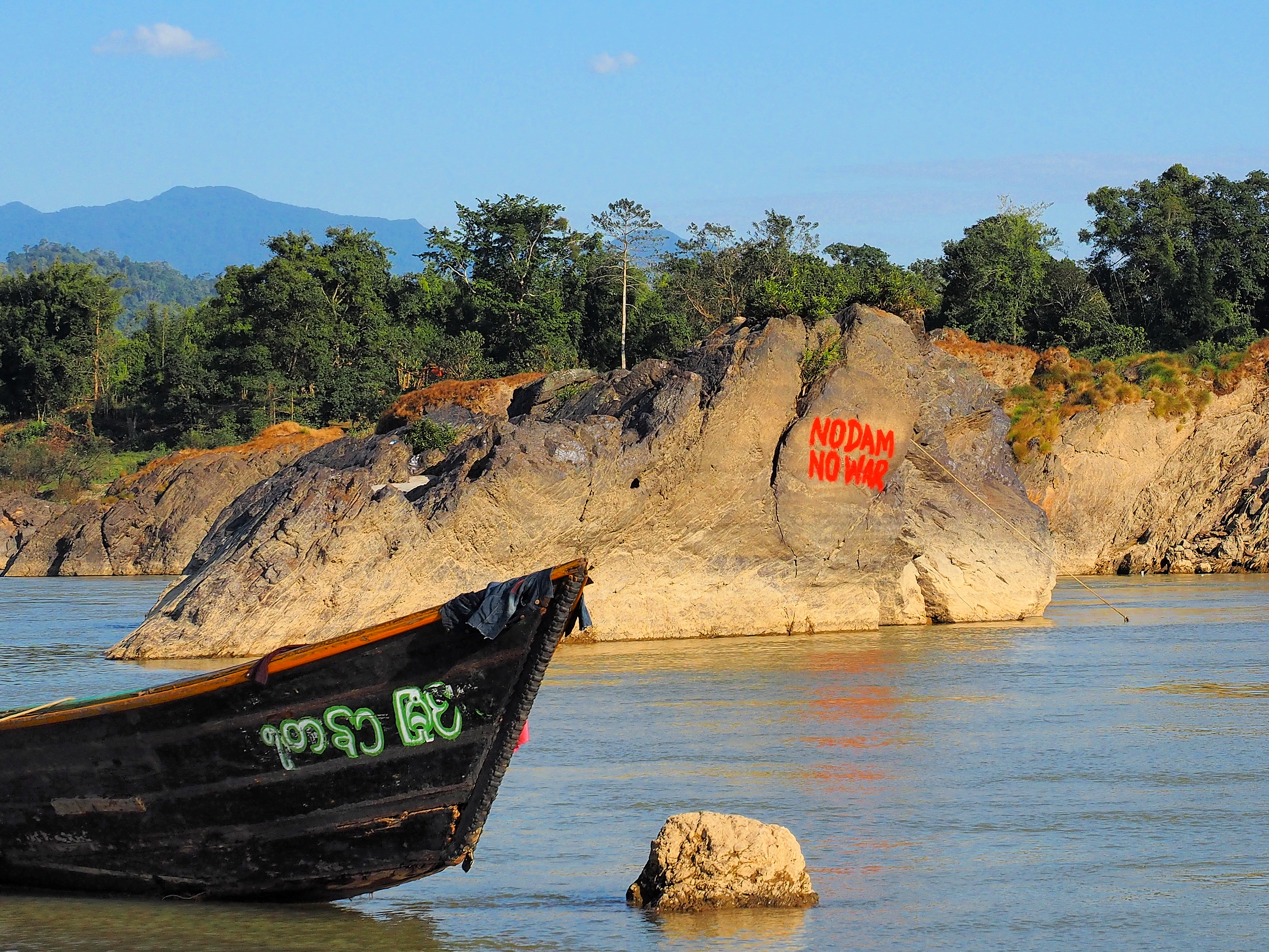 Graffiti Graffiti near the Myitsone Dam, expressing popular Kachin sentiments about the root causes of the ongoing civil war. Image by Doug Bock Clark. Myanmar, 2017.