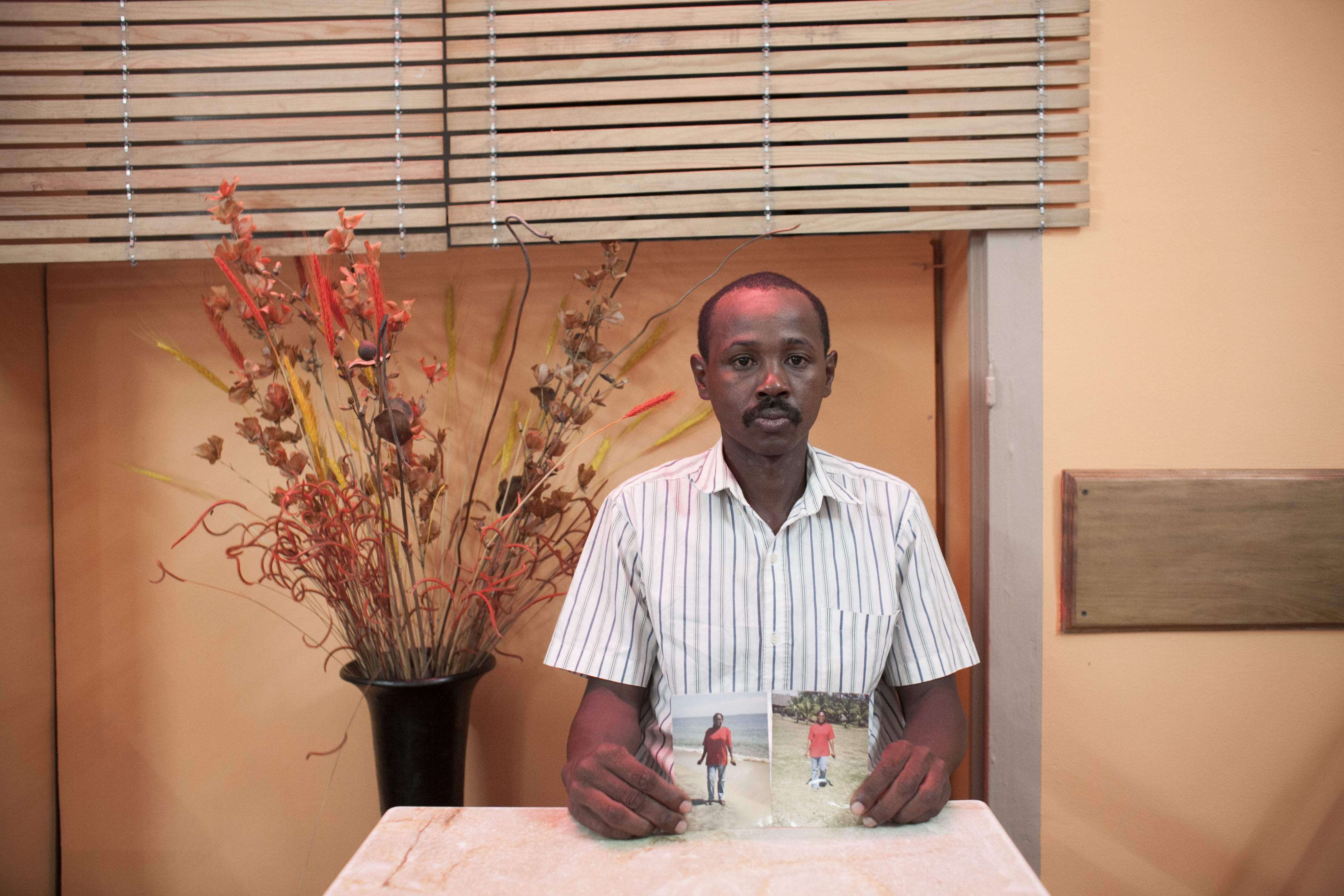 Maurice Pierre Herynirina holds a photograph of his wife, Solange Razafindrasoa, in an Antananarivo cafe last December. He learned in February that she had died in Saudi Arabia, where she was working as a domestic servant. Image by Rijasolo / Riva Press. Madagascar, 2013. Media file: hery.jpg