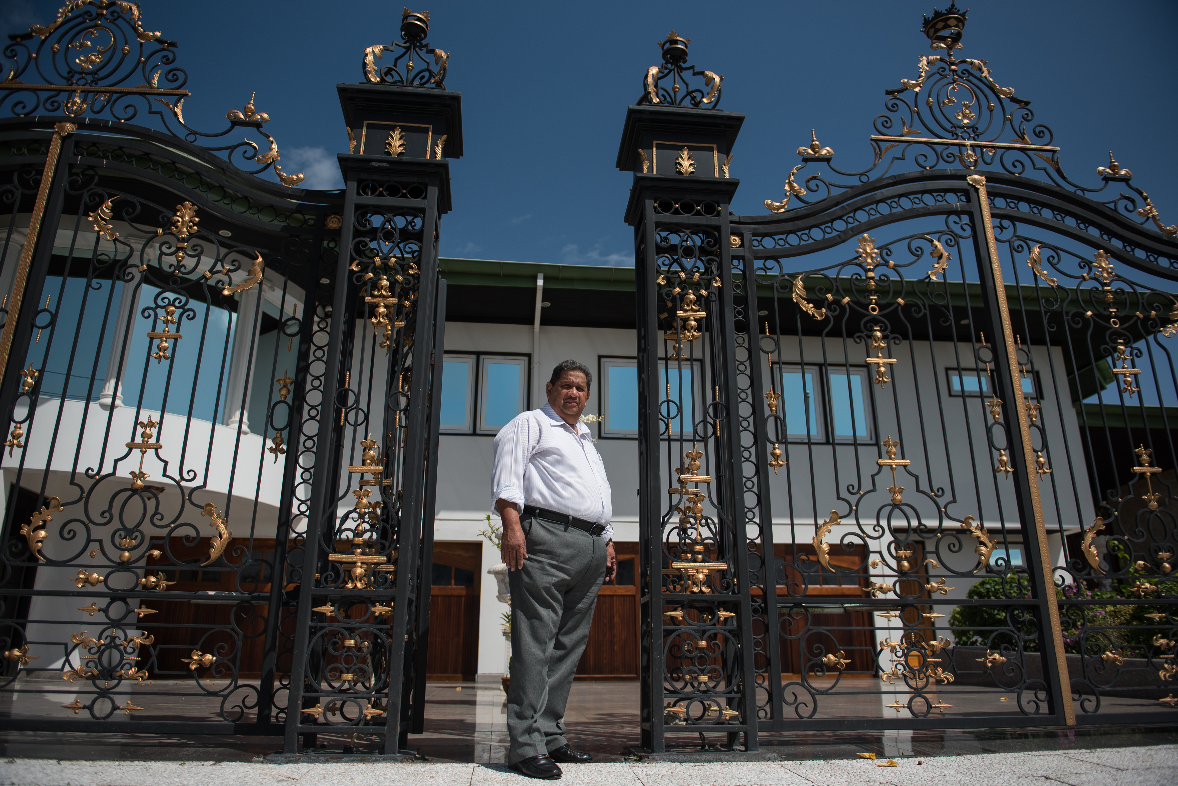 Rudi Dilip Sardjoe at the gates of his residential and office compound in Paramaribo, Suriname. Image by Stephanie Strasburg. Suriname, 2017. Rudi Dilip Sardjoe at the gates of his residential and office compound in Paramaribo, Suriname. Image by Stephanie Strasburg. Suriname, 2017.