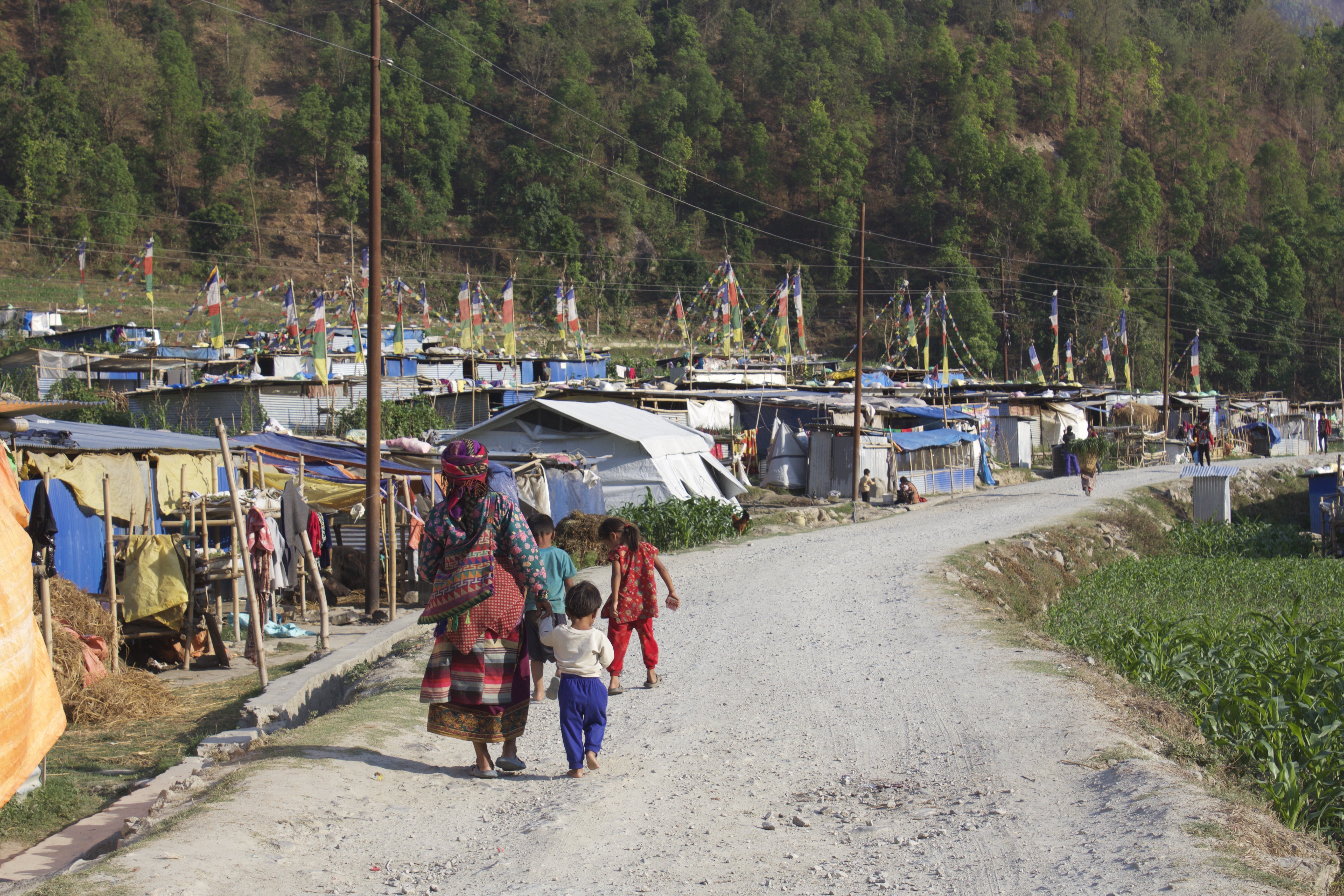 The Himalayan village of Milung no longer exists. Where a house stood, only a doorway remains, surrounded by stones that rained down in a rockslide. The earthquake took 38 lives in this tiny community, more than 8000 across this rugged, isolated Himalayan country. A year after the deadly earthquake, reconstruction here has barely begun. The government promises money to earthquake victims, but politics, corruption and a lack of confidence in government have convinced some Nepalese to start reconstruction on their own. Images and caption by Richard Coolidge. Nepal, 2016. Media file: camp_mw.jpg
