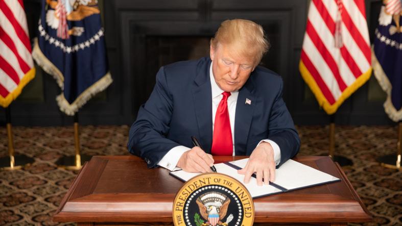 President Donald J. Trump signs an Executive Order in Bedminster, New Jersey, entitled “Reimposing Certain Sanctions with Respect to Iran.” Image courtesy of the White House. President Donald J. Trump signs an Executive Order in Bedminster, New Jersey, entitled “Reimposing Certain Sanctions with Respect to Iran.” Image courtesy of the White House.