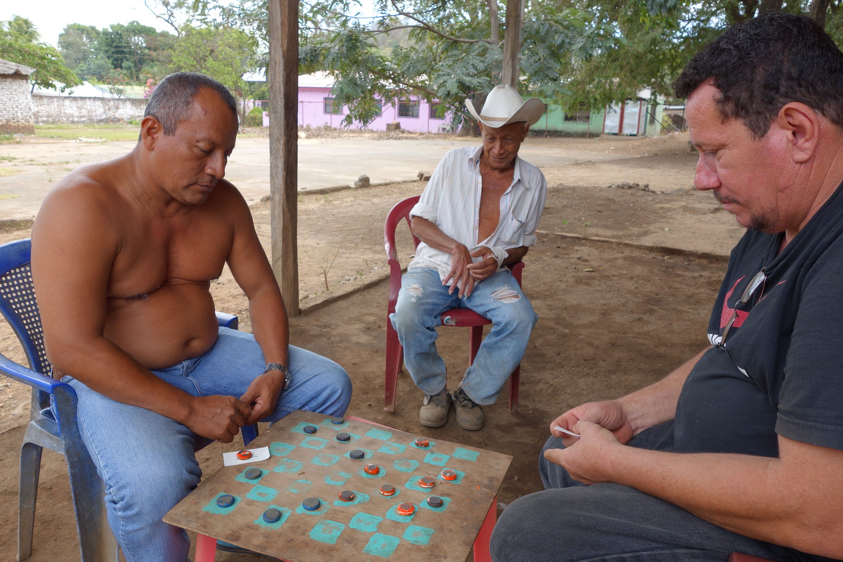 Carpenter Ernesto Salinas from the town of Tola thinks the canal is a good idea but worries about whether the government will reimburse him for his 500-acre ranch which lies in the canal's footprint. Image by Chris Kraul. Nicaragua, 2015. Media file: nicacanalcheckers.jpg