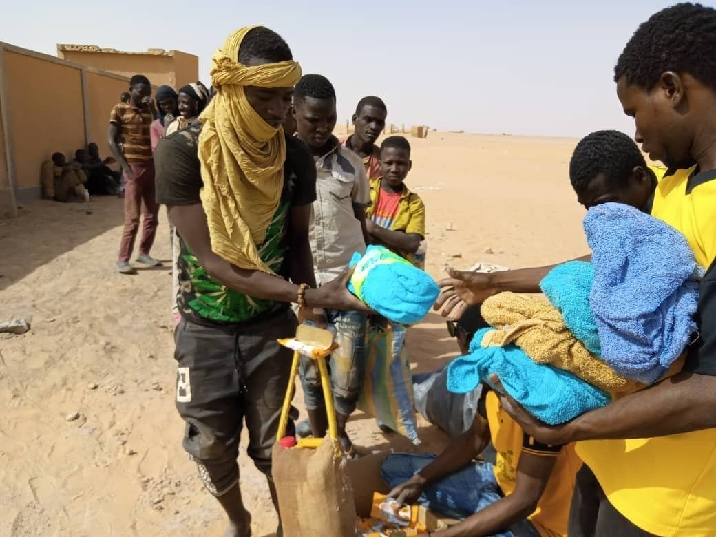 In this April 25, 2020 photo provided by IOM Niger, some of nearly 100 Nigeriens arrive in Assamaka, Niger, on foot from Algeria and now must be quarantined for two weeks at the remote Sahara border settlement, where water is scarce and midday temperatures reach over 110 degrees (45 degrees Celsius). Globally, coronavirus has marooned thousands of migrants in some of the world's harshest conditions on land and at sea. (IOM Niger via AP) In this April 25, 2020 photo provided by IOM Niger, some of nearly 100 Nigeriens arrive in Assamaka, Niger, on foot from Algeria and now must be quarantined for two weeks at the remote Sahara border settlement, where water is scarce and midday temperatures reach over 110 degrees (45 degrees Celsius). Globally, coronavirus has marooned thousands of migrants in some of the world's harshest conditions on land and at sea. (IOM Niger via AP)