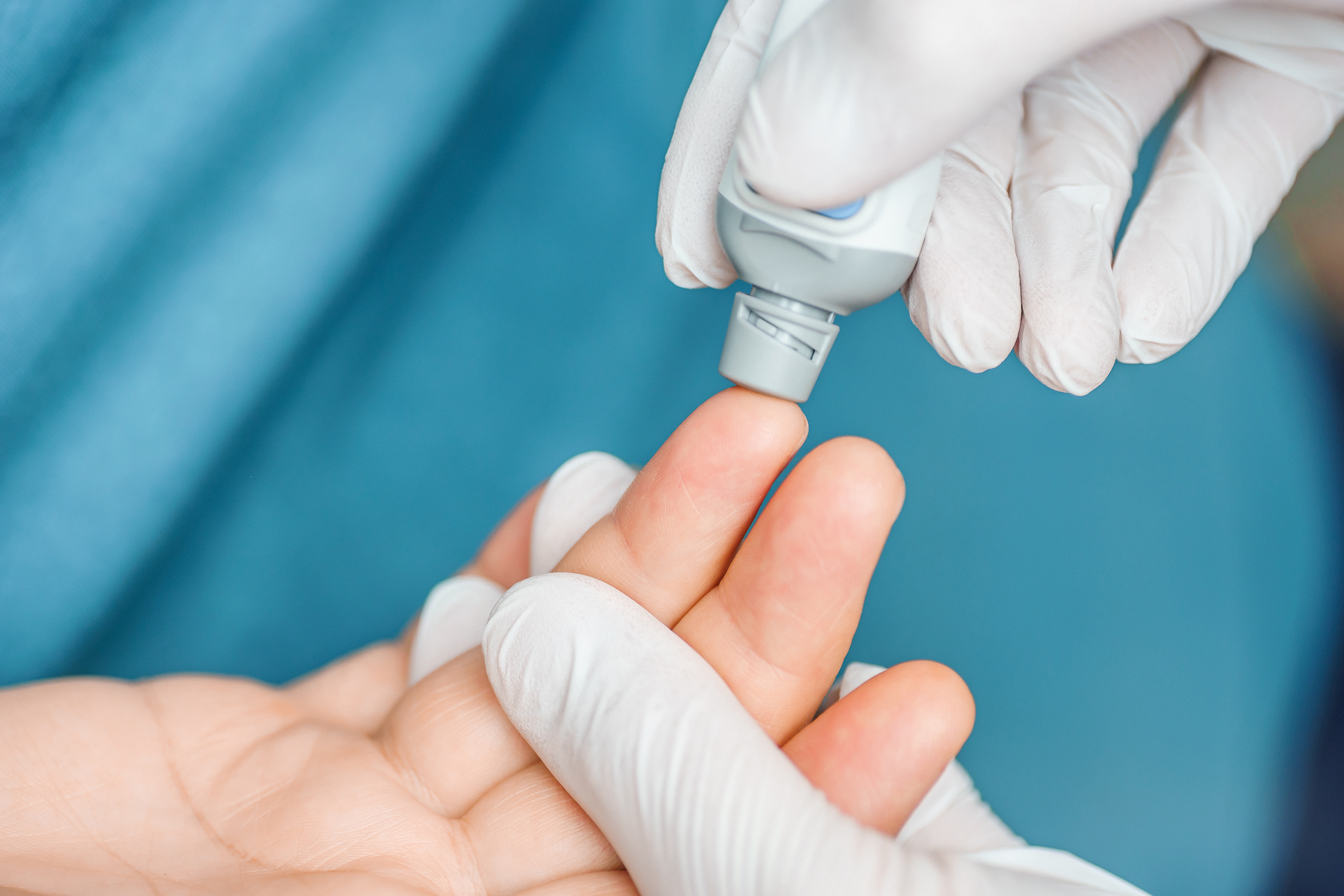 A doctor tests a patient's blood at the hospital. Image via Shutterstock.