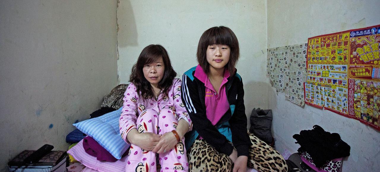Laing Hongqin, 38, and Li Xiaoxue, 18, are both from Hebei province. They work as vendors in a department store in the capital. Image by Sim Chi Yin / VII. China, 2015. Media file: rattribe1.jpg