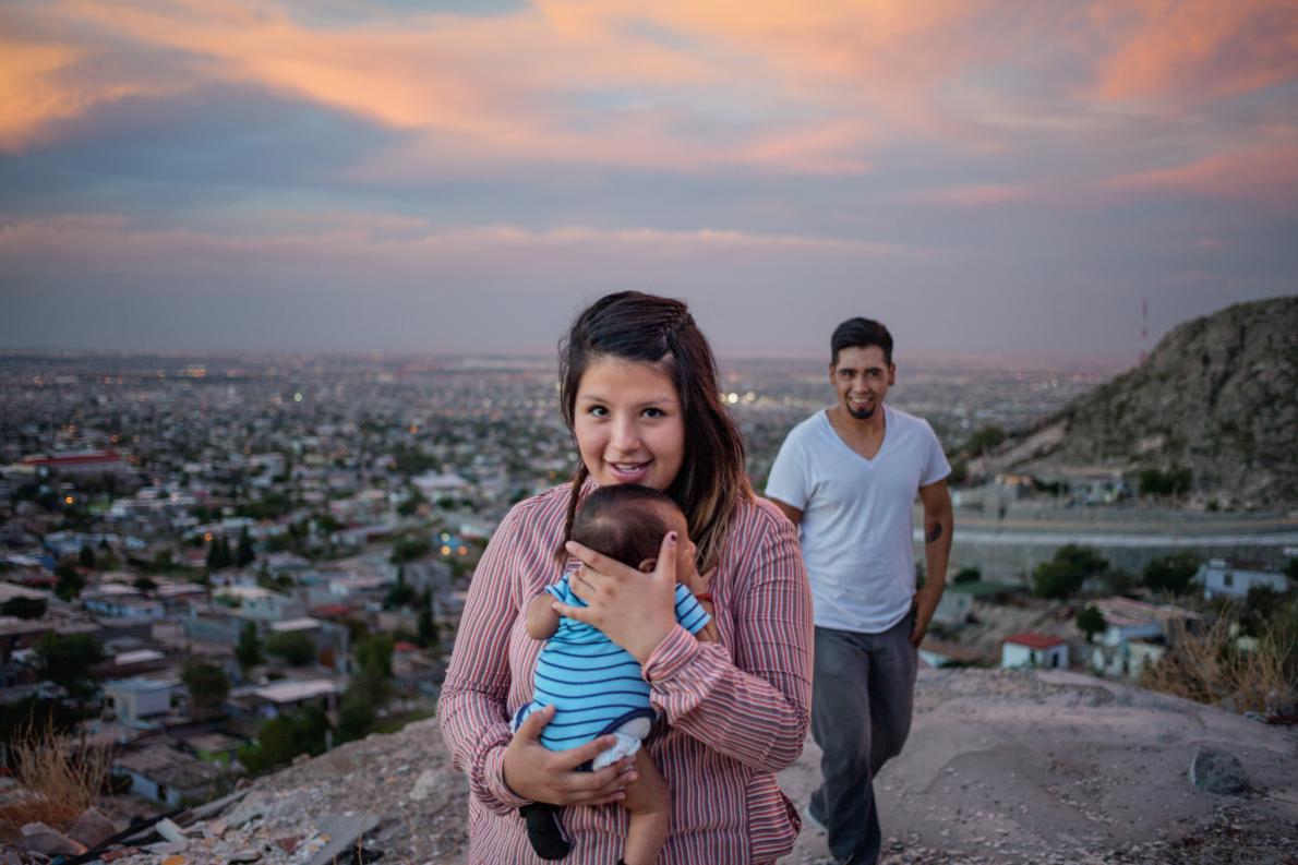 Denise Fuentes and Ulises Escobedo, posing on an overlook with baby Eros, both were touched by the drug war that raged in the neighborhood below. Now they’re searching for a home there. Image by Dominic Bracco II. Mexico, 2015. Media file: mm8388_150724_44206.ngsversion.1463164849638.adapt_.1190.1.jpg