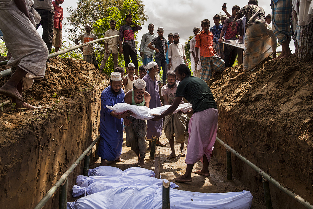 Bengali residents from the nearby Inani village donated the land and dug the mass grave for the 15 bodies recovered near their Inani Beach. Of the more than 100 Rohingyas from a boat that had capsized in the Bay of Bengal, only 17 people survived. Image by Patrick Brown/Panos Pictures/UNICEF. Bangladesh, 2017. Bengali residents from the nearby Inani village donated the land and dug the mass grave for the 15 bodies recovered near their Inani Beach. Of the more than 100 Rohingyas from a boat that had capsized in the Bay of Bengal, only 17 people survived. Image by Patrick Brown/Panos Pictures/UNICEF. Bangladesh, 2017.