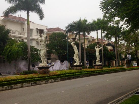 Statues of Greek gods on a tree lined road in Ciputra International City, in Hanoi’s Tay Ho district. Image by Claire Provost. Vietnam, 2015.