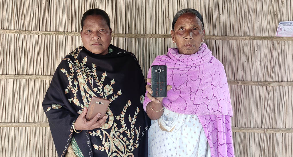 Dinomoni Burman and Swarnobala Roy have successfully ensured they got the documentation for the land ownership done with the help of mobile phone. Image by Gurvinder Singh / VillageSquare. India, undated. Dinomoni Burman and Swarnobala Roy have successfully ensured they got the documentation for the land ownership done with the help of mobile phone. Image by Gurvinder Singh / VillageSquare. India, undated.