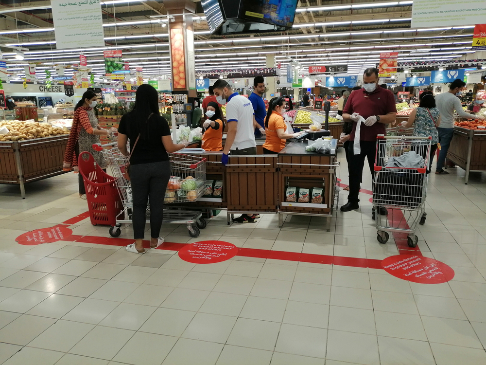 A supermarket stipulates social distancing for customers during the novel coronavirus pandemic outbreak. Image by Arnold O. A. Pinto / Shutterstock.com. United Arab Emirates, 2020. A supermarket stipulates social distancing for customers during the novel coronavirus pandemic outbreak. Image by Arnold O. A. Pinto / Shutterstock.com. United Arab Emirates, 2020.