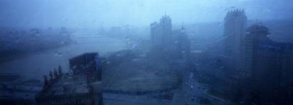 Buildings are seen through a storm in Yanji, China. The city of Yanji is a major hub for North Korean escapees and defectors. Image © Tomas van Houtryve/VII. China, 2013. Media file: 001_web_edit_borderlinenk.jpg