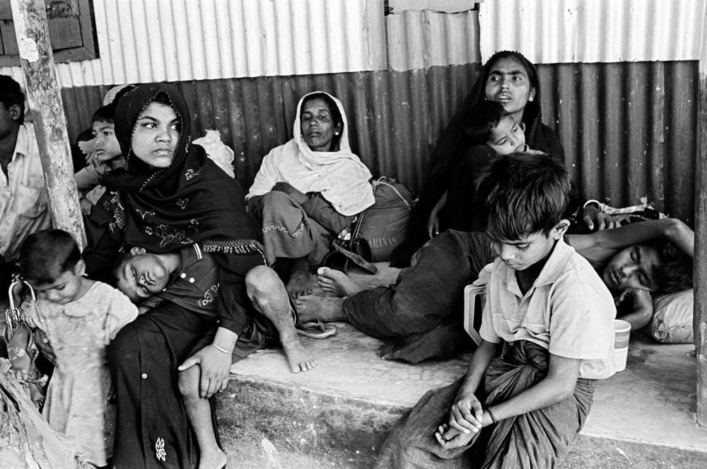 Exhausted from their journey out of Burma, this group of twenty Rohingya was detained by Bangladesh Border Guards (BDR) right after their boat had crossed the Naf River from Burma and landed in the Shapuridip area of southern Bangladesh. BDR would push the entire group back to Burma the same night. Many in the group returned to Bangladesh the next day. Image by Greg Constantine. Bangladesh, 2012. Media file: 050212ro-29_0-1.jpg