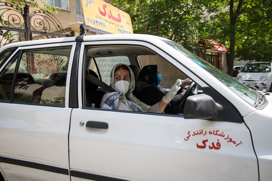 Maryam Rezaie, 58, works as a driving instructor in the capital Tehran and supports her family financially. But wearing a mask and gloves along with the headscarf is an additional limitation in the car. Maryam is afraid of getting infected at work. Image by Mehdi Fazlollahi / NVP Images. Iran, 2020. Maryam Rezaie, 58, works as a driving instructor in the capital Tehran and supports her family financially. But wearing a mask and gloves along with the headscarf is an additional limitation in the car. Maryam is afraid of getting infected at work. Image by Mehdi Fazlollahi / NVP Images. Iran, 2020.