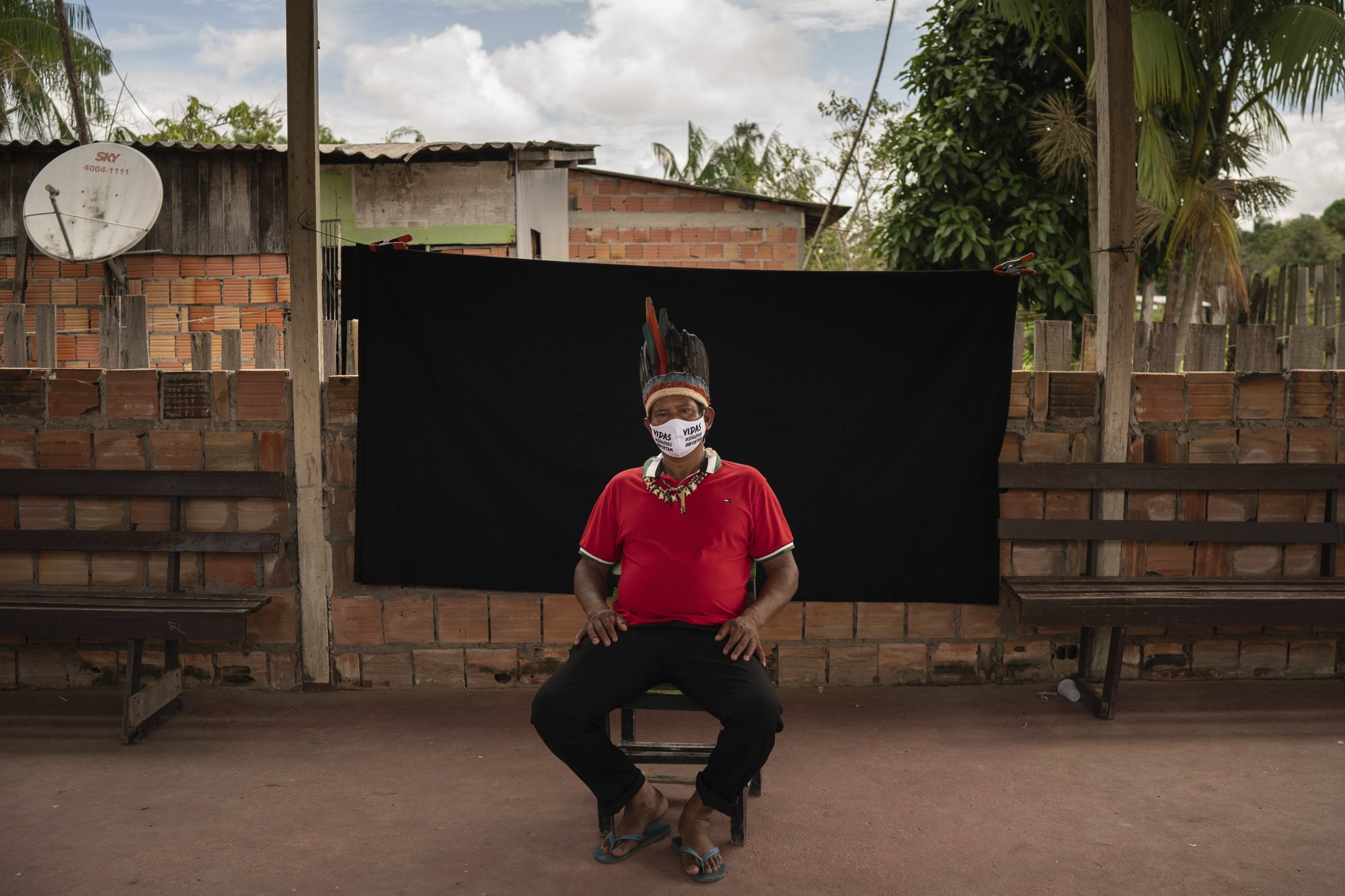 Indigenous leader Jose Augusto, 48, of the Miranha indigenous ethnic group, poses for a portrait wearing a face mask amid the spread of the new coronavirus, at the Park of Indigenous Nations community in Manaus, Brazil, Thursday, May 28, 2020. His mask reads in Portuguese: "Indigenous lives matter." Image by Felipe Dana / AP Photo. Brazil, 2020. Indigenous leader Jose Augusto, 48, of the Miranha indigenous ethnic group, poses for a portrait wearing a face mask amid the spread of the new coronavirus, at the Park of Indigenous Nations community in Manaus, Brazil, Thursday, May 28, 2020. His mask reads in Portuguese: "Indigenous lives matter." Image by Felipe Dana / AP Photo. Brazil, 2020.