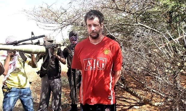 Michael Scott Moore surrounded by his Somali captors, who demanded a $20 million ransom. Image taken from hostage video made by kidnappers.