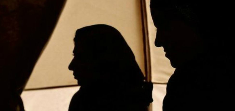 Yazidi women in silhouette. BBC.