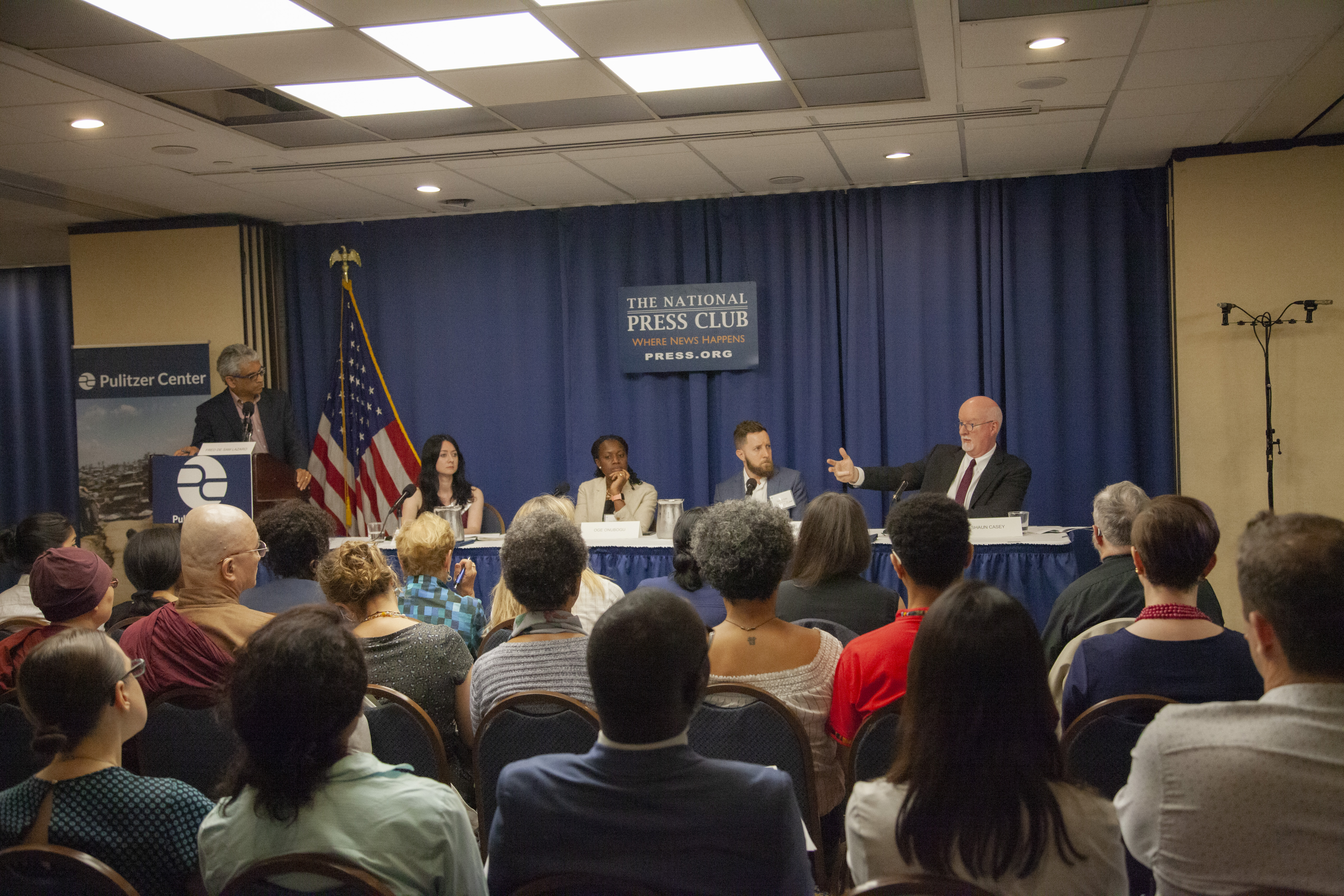 Fred de Sam Lazaro (far left) discusses religion and peacebuilding with Cathy Otten (second from left), Oge Onubogu (center), Danny Gold (second from right), and Shaun Casey (far right). Image by Jin Ding. Washington, D.C., 2019. Fred de Sam Lazaro (far left) discusses religion and peacebuilding with Cathy Otten (second from left), Oge Onubogu (center), Danny Gold (second from right), and Shaun Casey (far right). Image by Jin Ding. Washington, D.C., 2019.